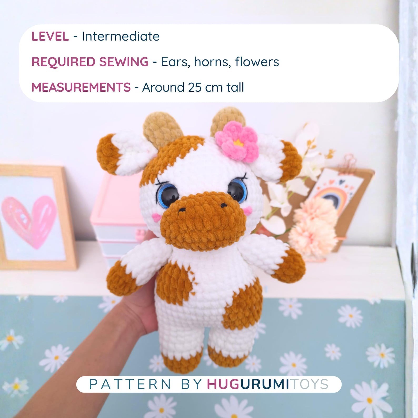 Amigurumi crochet cow wearing blue overalls sitting on a white background – view 2